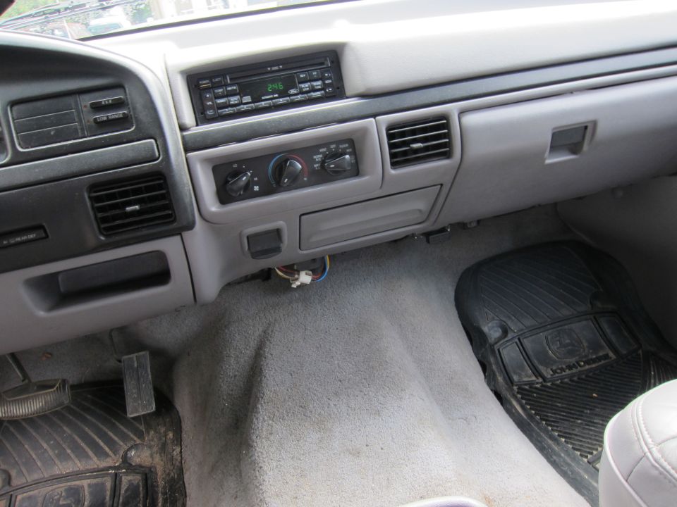 Car interior dashboard with radio, climate controls, and air vents