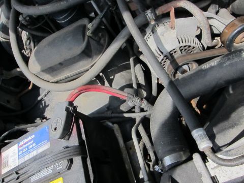 1991 Ford LTD Crown Victoria - Close-up view of an engine bay, focusing on the battery and alternator components.
