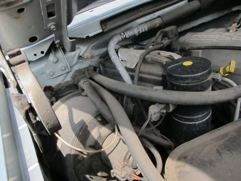 1991 Ford LTD Crown Victoria - Close-up view of a vehicle's engine bay, showing various components and hoses.