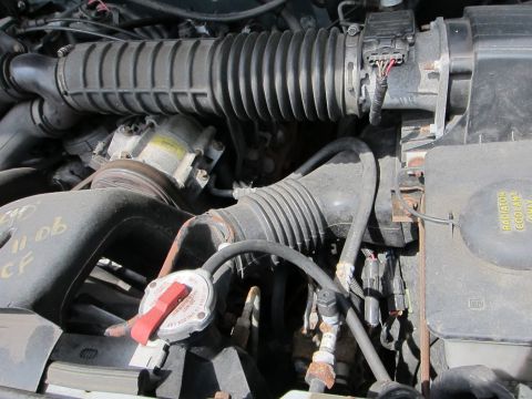 1991 Ford LTD Crown Victoria - Close-up of an engine bay's air intake system with various hoses and components visible.