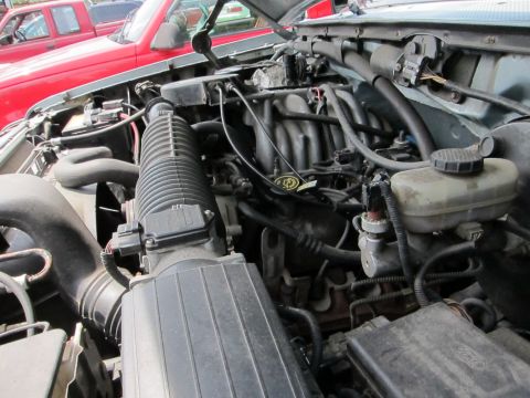 1991 Ford LTD Crown Victoria - The engine bay of a vehicle, showing various components including the air intake system and brake fluid reservoir.