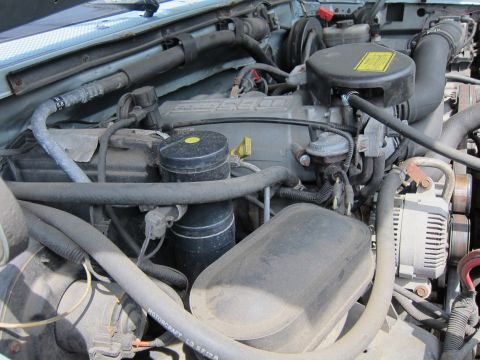 1991 Ford LTD Crown Victoria - Close-up view of the engine compartment, showing various mechanical components and wiring.