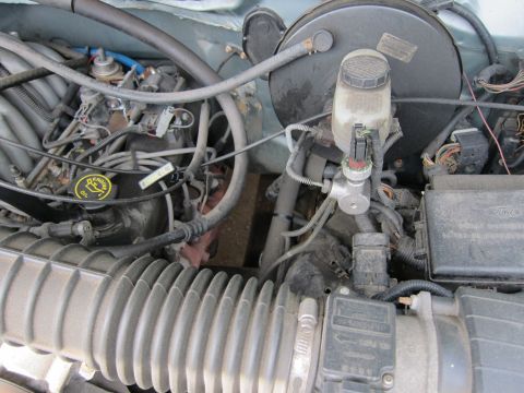 1991 Ford LTD Crown Victoria - Close-up view of a vehicle's engine bay, showing various components and wiring.