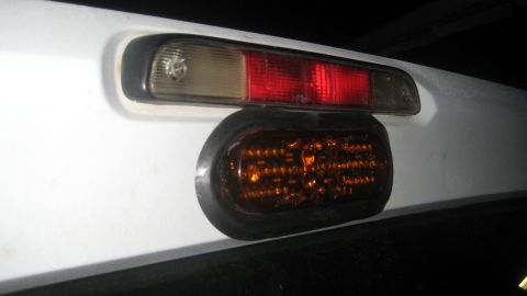 1996 Ford Bronco - An aftermarket amber LED light is mounted below the factory third brake light assembly.