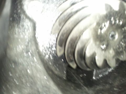 1995 Ford Bronco - A close-up view of a differential gear, showing its intricate teeth and metallic sheen.