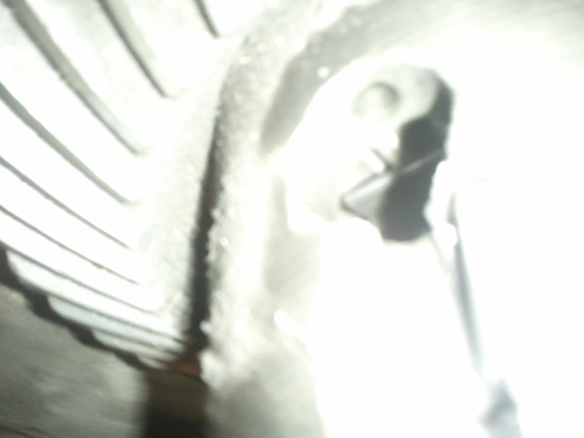 Close-up of tire tread pattern and a suspension part
