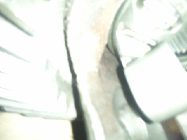 Vehicle interior with a dark seam running vertically down the center, and white panels on either side. A Supermotors logo is visible at the bottom right