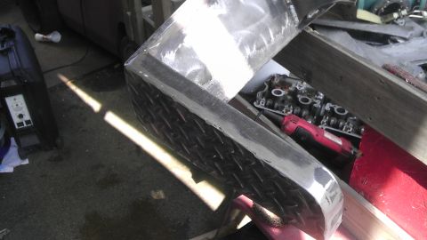 1989 Ford Bronco - A metal fabrication project is underway, with an engine part and tools visible.