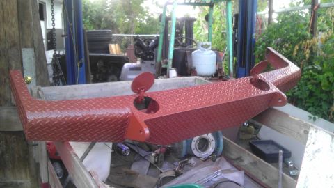 1989 Ford Bronco - A custom red diamond plate bumper with a flip-up cap for a fuel filler opening is shown.