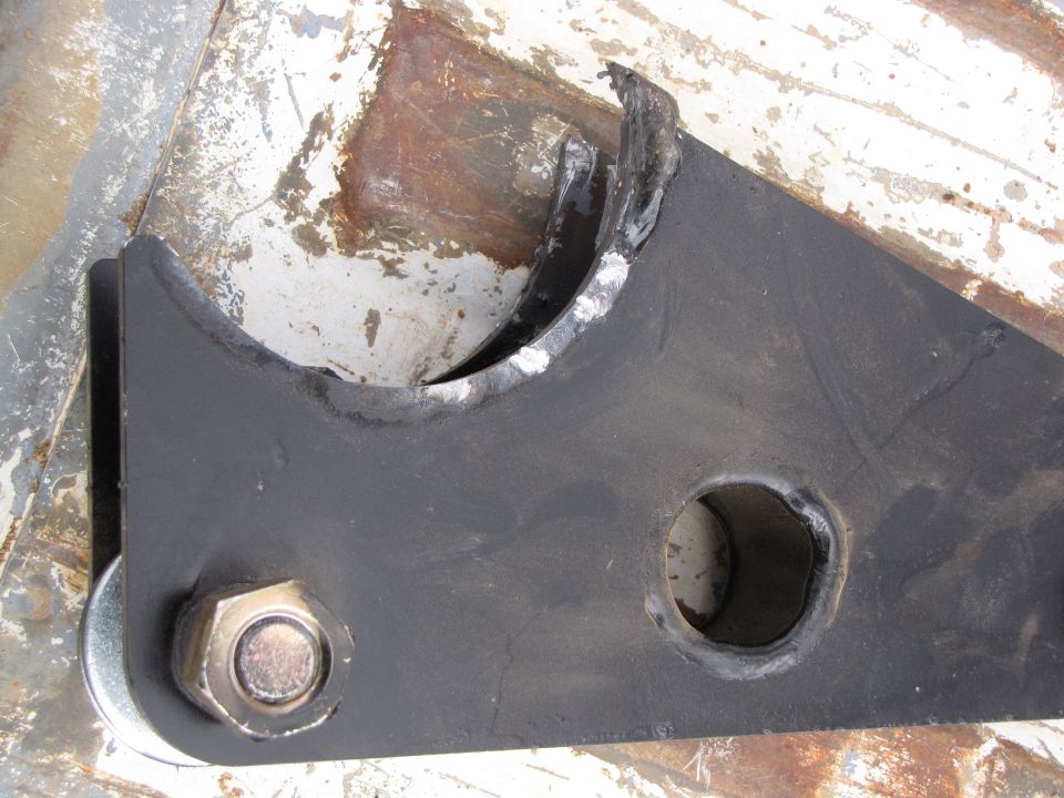 Black metal suspension part with a bolt and washer