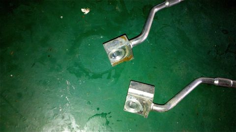 1995 Ford F-150 - Close-up of two metal fuel lines with fittings, likely for a vehicle's fuel system.