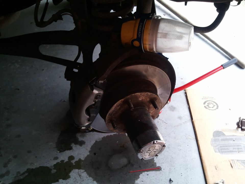 Front brake assembly with hubcap and attached light