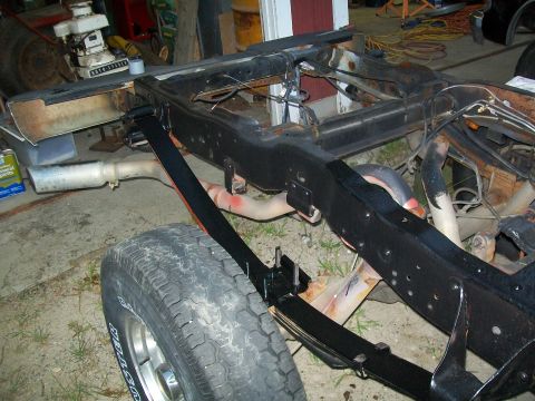 1995 Ford F-150 - The frame and rear suspension of a 1995 Ford F-150 are visible, with a leaf spring assembly and exhaust pipe in view.