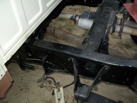 1995 Ford F-150 - Underside view of a truck's frame with exhaust pipes and fuel system parts visible.