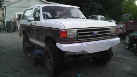 1989 Ford Bronco - This 1989 Ford Bronco features a custom diamond plate front bumper and two-tone paint scheme.