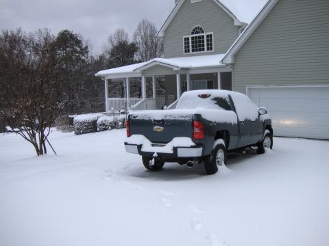 1982 Chevrolet Camaro - Pickup truck parked in front of a house during a snowfall.
