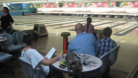 1996 Ford Bronco - People are gathered at a bowling alley, with lanes stretching into the distance.