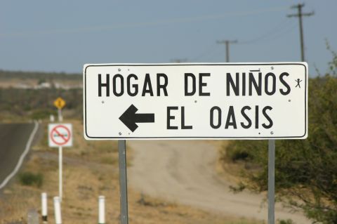 1986 Ford Bronco - A road sign indicates the direction to El Oasis, a children's home.