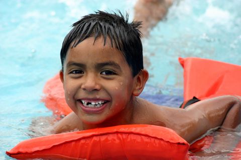 1986 Ford Bronco - Child enjoys a swim in the pool with an inflatable float.