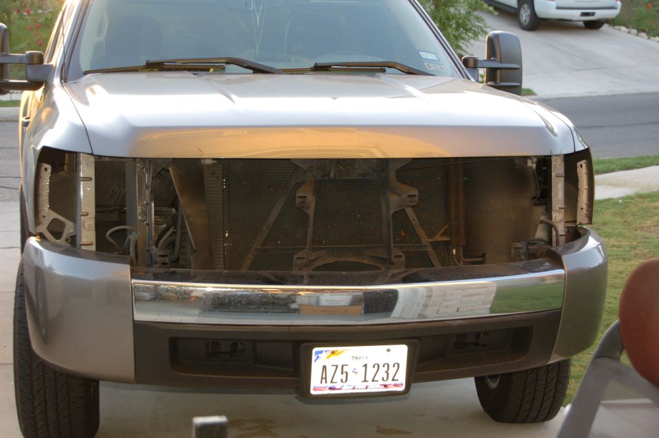 Front of a truck with grille and bumper visible, but headlights removed. License plate AZ5-1232 is on the front
