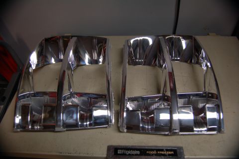 2007 Chevrolet Silverado 1500 - Pair of chrome headlight bezels, likely aftermarket parts, displayed on a surface.