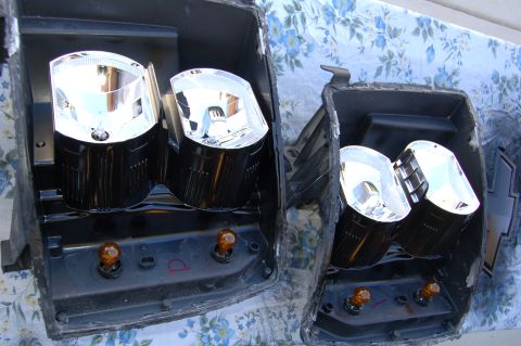 2007 Chevrolet Silverado 1500 - Two disassembled headlights are shown, likely for modification or repair, with amber bulbs visible in the housings.
