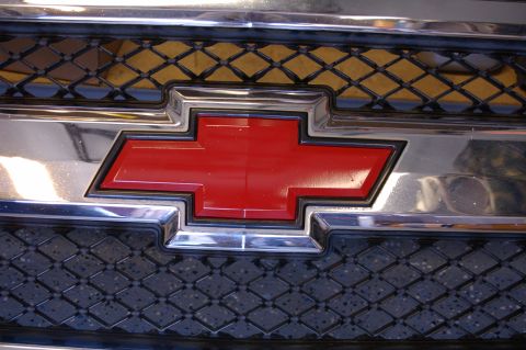 2007 Chevrolet Silverado 1500 - Close-up of the red Chevrolet bowtie emblem on the front grille of a 2007 Chevrolet Silverado 1500.