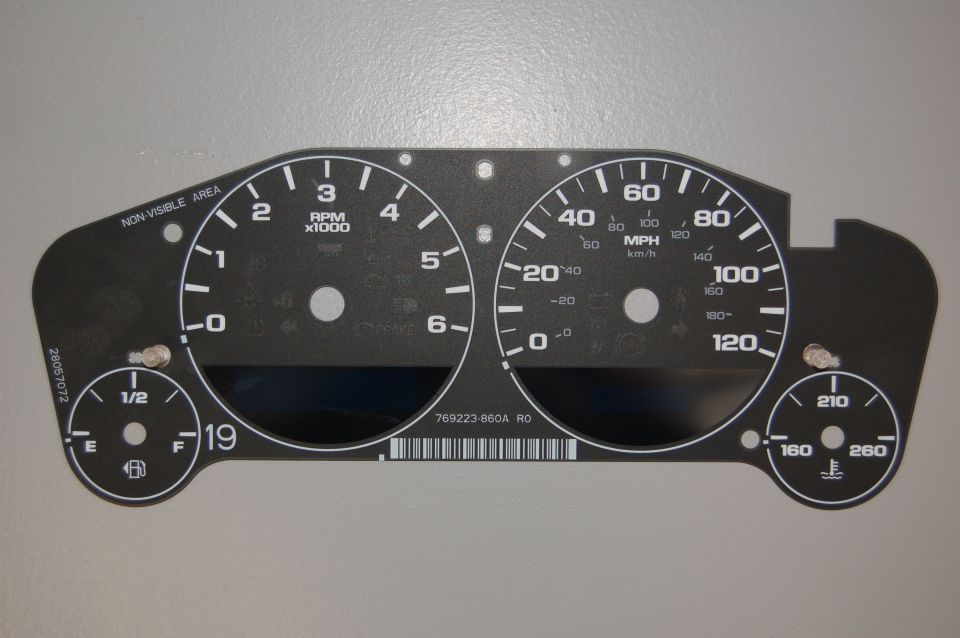 Gauge cluster face with MPH, RPM, fuel, and temperature gauges. Part number 769223-860A R0 visible