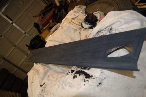 2007 Chevrolet Silverado 1500 - A dark gray interior trim piece with a cutout is shown, possibly from a vehicle.