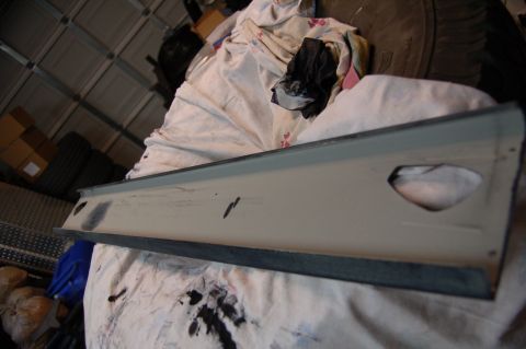2007 Chevrolet Silverado 1500 - An interior trim piece, possibly from a Chevrolet Silverado 1500, is shown resting on a cloth in a garage setting.