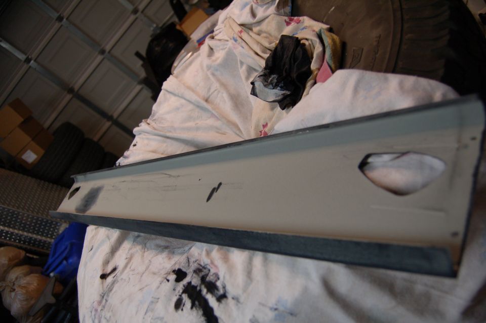 Interior trim piece with cutouts, resting on cloth