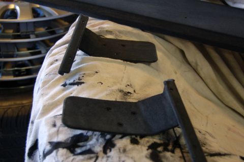 2007 Chevrolet Silverado 1500 - Interior shelf brackets are shown on a white cloth, with a tire and wheel visible in the background.
