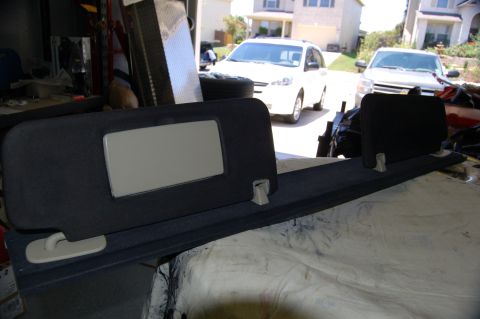 2007 Chevrolet Silverado 1500 - Two vehicles are visible in the background, a white minivan and a silver SUV, parked in a driveway.