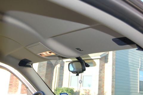 2007 Chevrolet Silverado 1500 - The interior overhead console and rearview mirror assembly of a 2007 Chevrolet Silverado 1500 is visible from the driver's perspective.