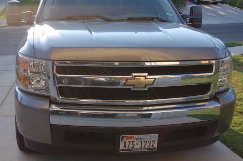 2007 Chevrolet Silverado 1500 - Front view of a gray Chevrolet Silverado 1500 pickup truck with a chrome grille and tow mirrors.