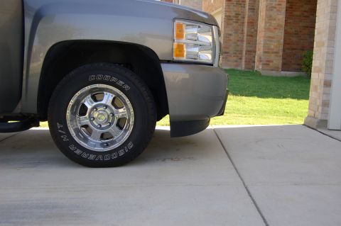 2007 Chevrolet Silverado 1500 - The front passenger side of a gray Chevrolet Silverado pickup truck is visible, parked on a concrete driveway.