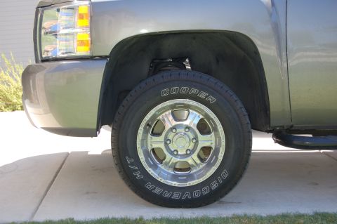 2007 Chevrolet Silverado 1500 - Close-up of the front passenger side wheel and fender of a 2007 Chevrolet Silverado 1500.