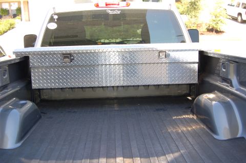 2007 Chevrolet Silverado 1500 - Rear view of a 2007 Chevrolet Silverado 1500 showing the bed liner and a diamond plate toolbox.