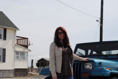 1991 Jeep YJ - A woman poses with a blue 1991 Jeep YJ in front of a house.