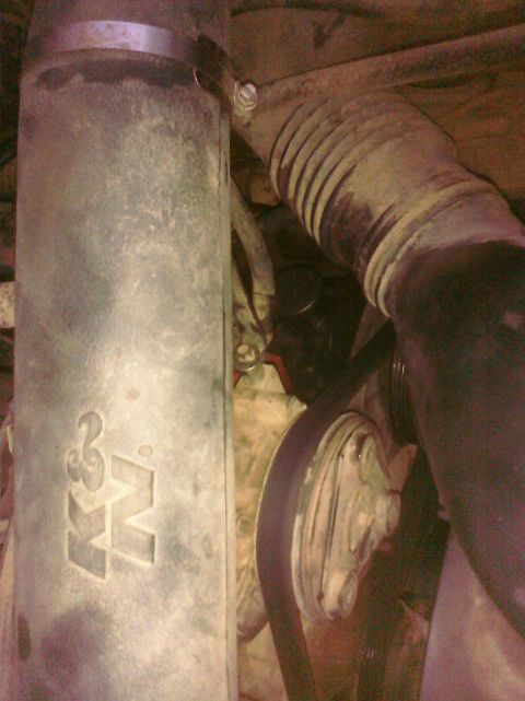 1995 Ford Bronco - Engine bay detail showing a K&N air filter housing and a ribbed intake hose.