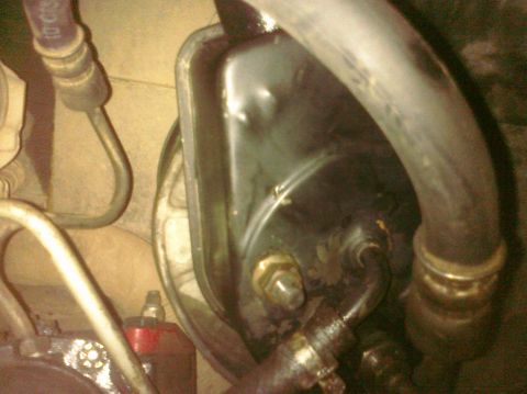 1995 Ford Bronco - This is a close-up view of a vehicle's power steering pump and associated hydraulic lines.