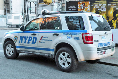 1991 Ford LTD Crown Victoria - A white NYPD traffic enforcement SUV is parked on a city street, displaying official markings and emergency lights.