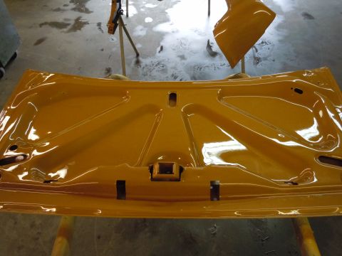 1970 Chevrolet Camaro - The underside of a yellow car hood is shown after being painted.