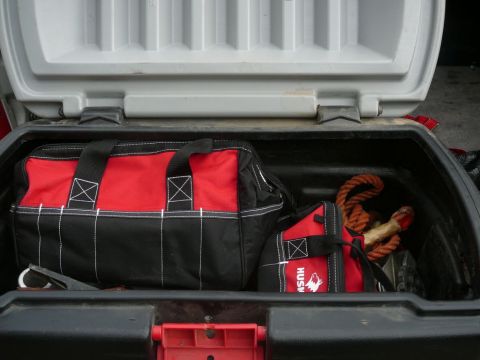 1988 Ford Bronco - Tool bags and rope stored in a vehicle's cargo area.