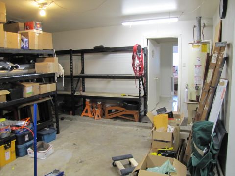1993 Ford F-250 - A cluttered garage scene with storage shelves, boxes, and various equipment.