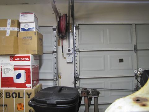 1993 Ford F-250 - Interior view of a garage with stacked boxes, a hose reel, and multiple garage doors visible.