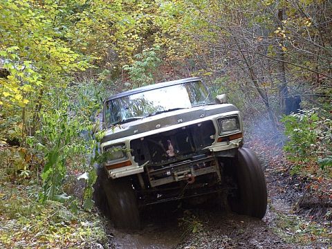 1978 Ford Bronco - Ford Bronco tackling a difficult muddy off-road path.