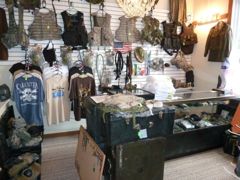 1992 Ford Mustang - Interior view of a military surplus store displaying various tactical gear and apparel.