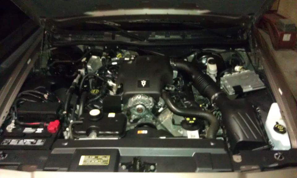 Engine bay of a 2007 Ford Crown Victoria showing V8 engine cover, air intake, and battery