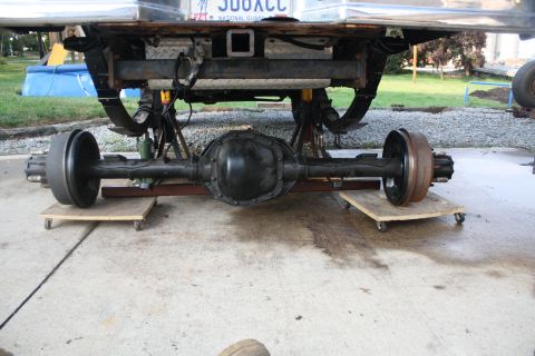 1996 Ford Bronco - The rear axle assembly is supported by dollies and positioned beneath the vehicle's frame.